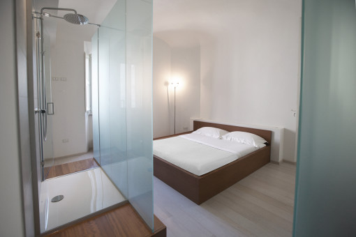 Nella camera Corner la doccia prende posto su un lato della stanza, celata da un grande pannello vetrato satinato.